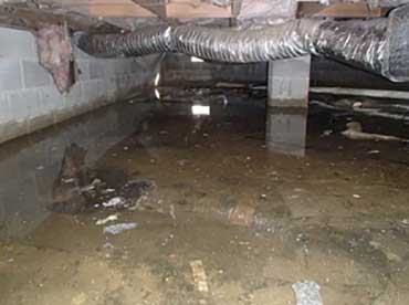 A flooded basement with a lot of water coming out of it.